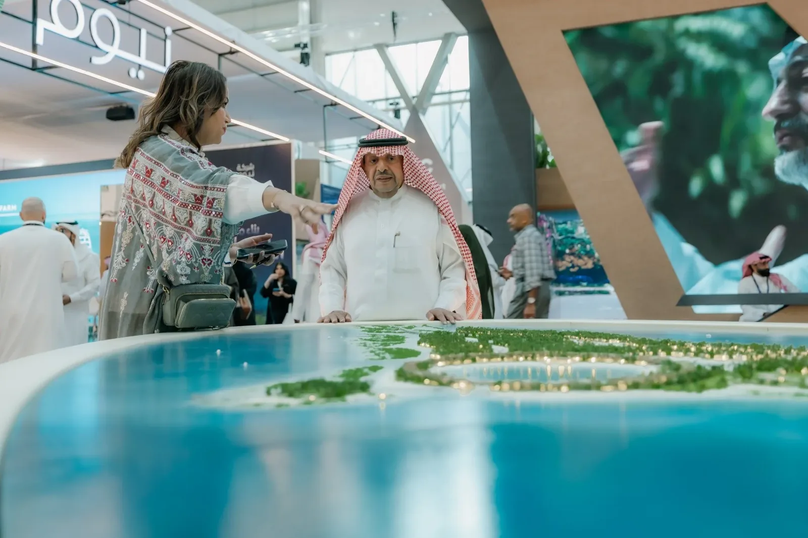 Visitors at a masterplan model on the exhibition floor at Cityscape Global in Riyadh